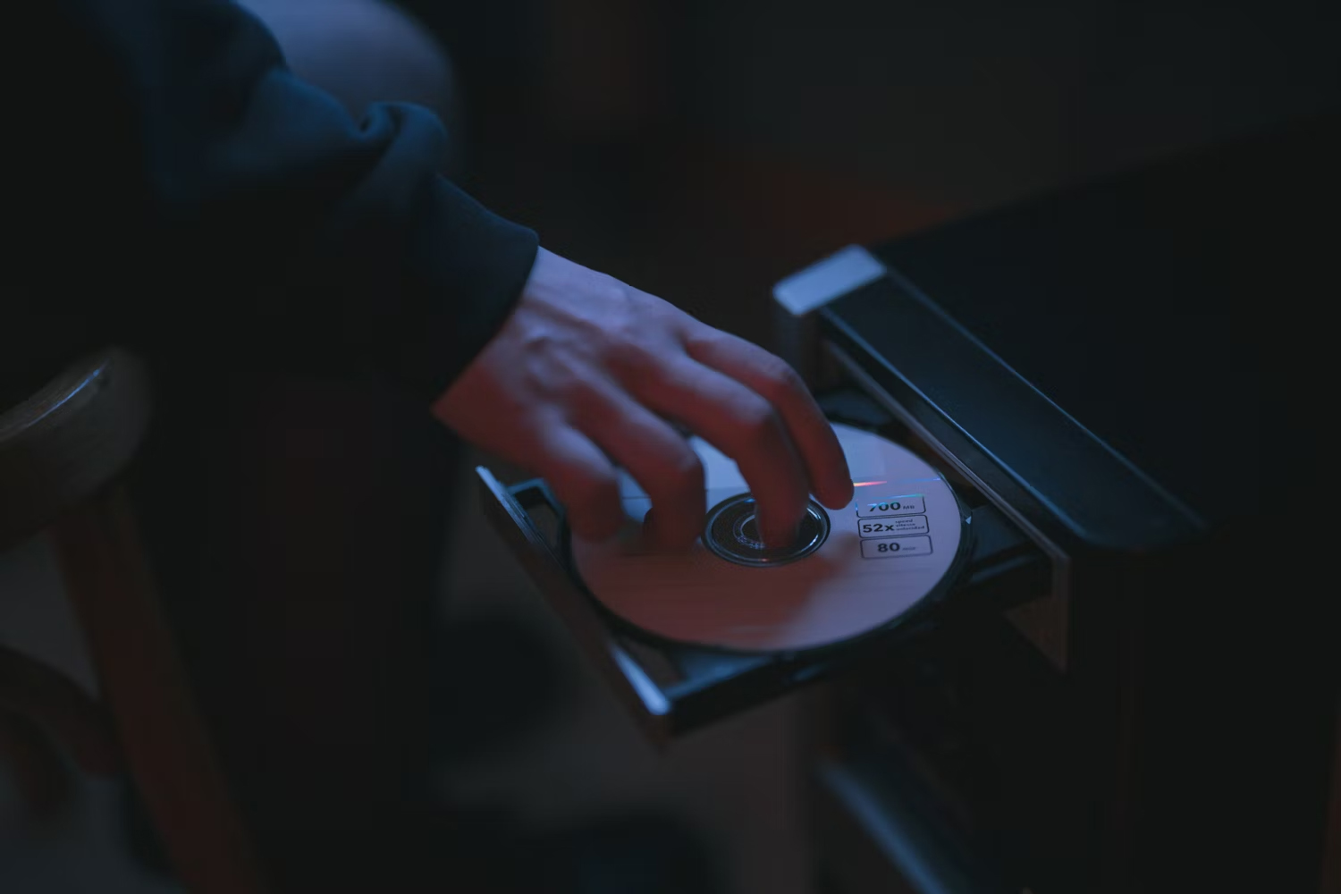 Person-Loading-CD-Into-Computer